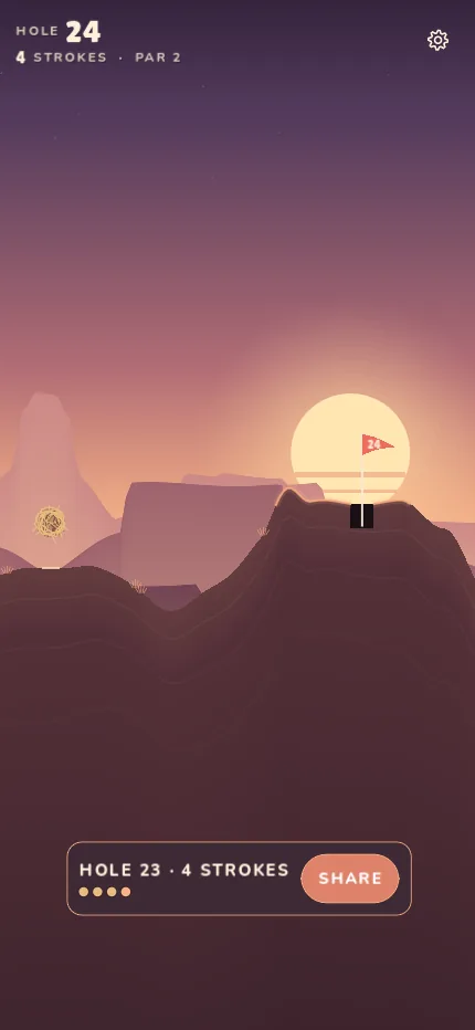 Hole 24 at dusk, the sun sitting behind the mesas